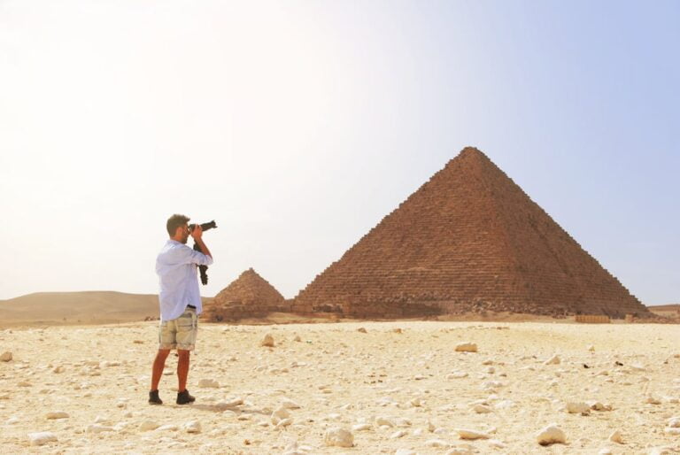 a man looking at the pyramids.